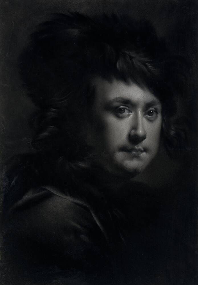Portrait of a man in monochrome, identified as Joseph Wright of Derby, turning right, facing forwards. He wears a fur or feathered hat and a coat or cloak trimmed in fur. His hair is loose beneath his hat. Made by Joseph Wright (1734 - 1797), c.1767-1770. Pastels on paper, presented in a window mount.
