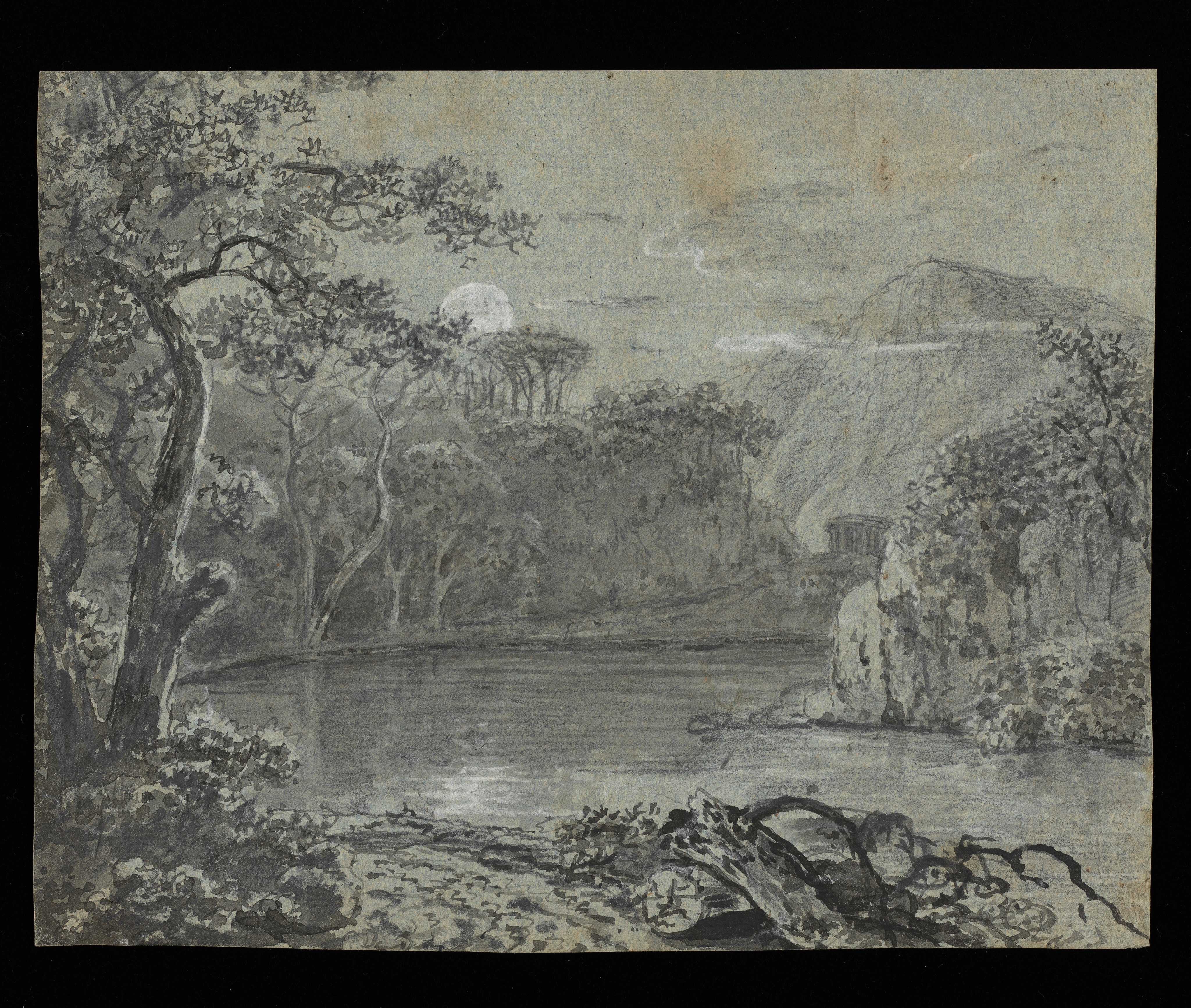 Drawing of a landscape with a lake or river, surrounded by cliffs and high ground. A circular collonaded building can be seen in the middle distance. The moon(?) rises behind some trees to the left of centre. There is a landscape study on the other side of this sheet. Made by Joseph Wright of Derby (1734-1797), c.1780-1781, pen and ink and ink wash over pencil with white chalk on blue-green paper.