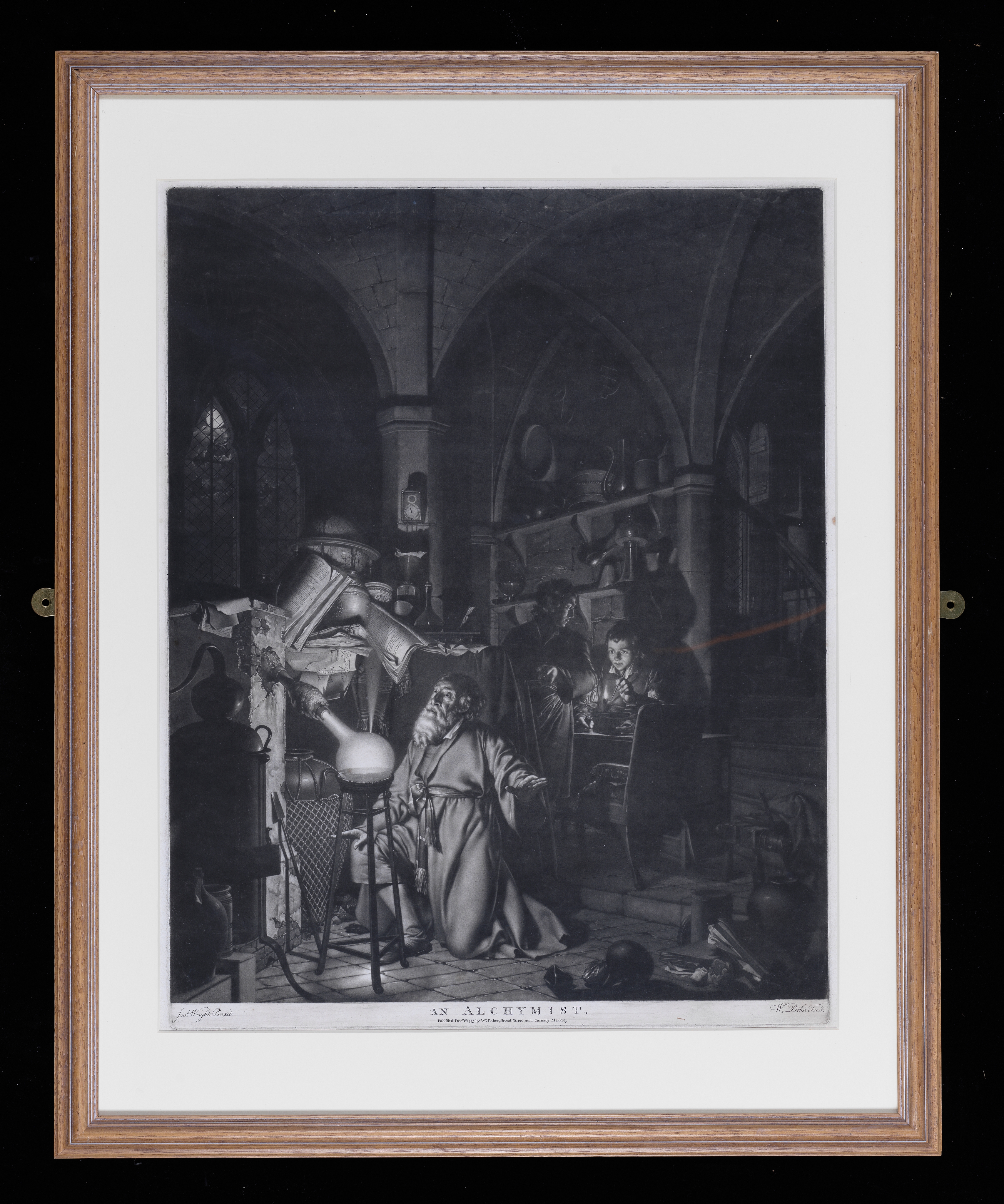 Mezzotint-engraving after Joseph Wright (1734-1797). `The Alchymist' Drawing upon such traditions, Wright’s alchemist kneels in awe before a flask from which a jet of phosphorus gas is released ‘and prays for the successful conclusion of his operation.’ Behind him two assistants, until recently engaged in extraction of lead from lead ore, stare on or point in amazement. Phosphorus was first discovered in 1676 and it is perhaps this event that Wright depicts here, the alchemist and his assistants’ ambiguous costume and gothic setting conveying some sense of a historical past. Inscribed, Bottom left hand corner 'JW Pinxit' centre 'An Alchymist/Published September 1775 and sold by W.Pether in Broad Street St James'' bottom right hand corner`Wm Pether Fecit'. Engraving after Wright; 'The Alchymist', Made by William Pether (1738-1821).Mezzontint-engraving and etching. Paper.