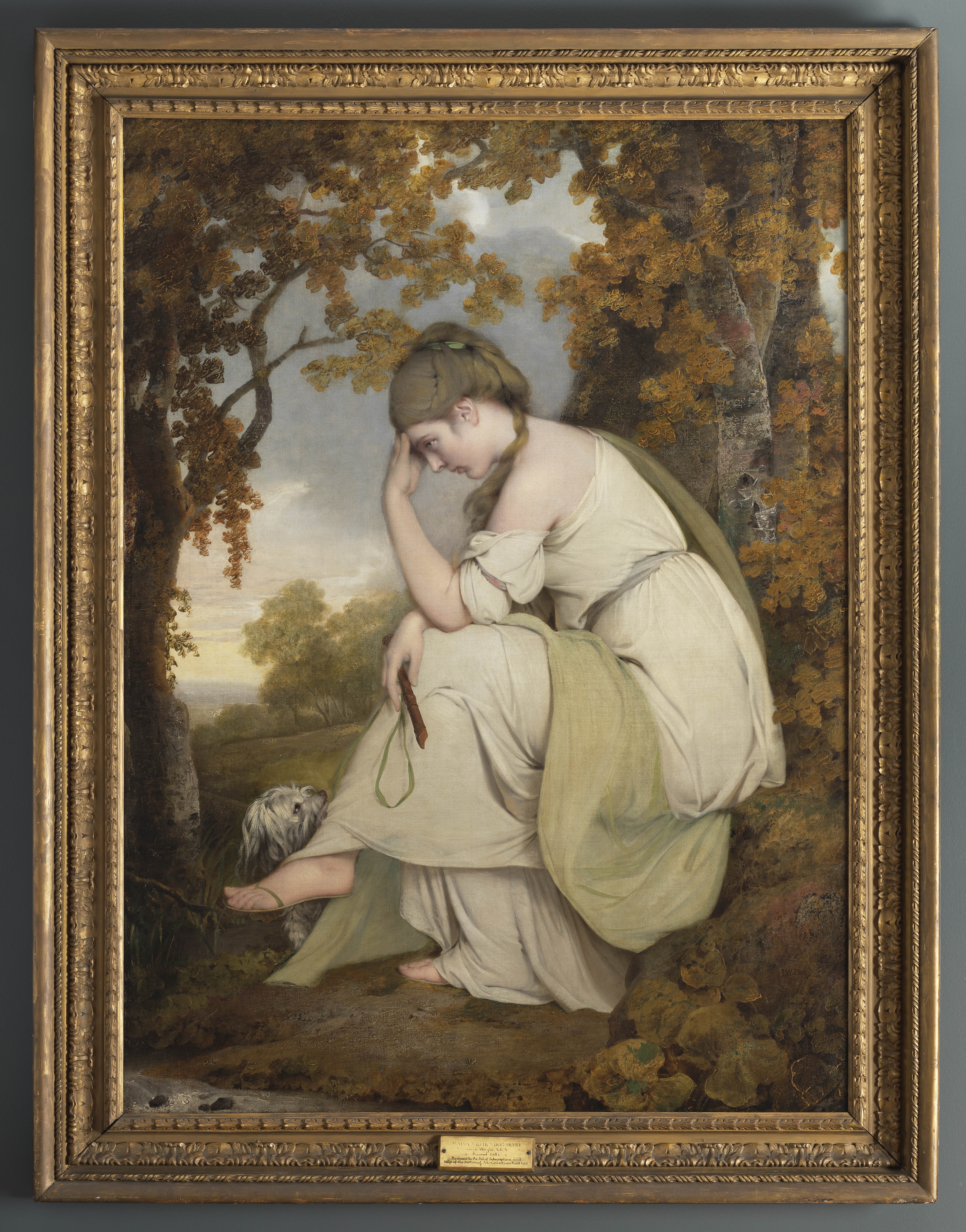 Painting of a woman, full length, facing left. She is seated in a landscape, with her head in resting in her left hand. In her right hand she holds a wooden recorder and green ribbon, which is attached to a small grey and white dog sitting at her feet. She is dressed in a classical-looking white gown, held at the waist by a light blue tie, and a long green shawl is draped over her right shoulder and over her left leg. She wears sandals. The landscape in which she is seated is green, with hints of autumn colour. Two trees, at either side of the canvas, frame the scene. The edge of a stream is visible in the lower left corner and beyond a green hill fringed by trees slopes away to the left to reveal a distant view of hills. An inscription on a rock to the lower right reads: 'I.W. Pinxt. / 1781'. Painted by Joseph Wright of Derby (1734 - 1797). Oil on canvas in gilded frame.

Painted by Joseph Wright of Derby (1734 - 1797). Oil on canvas in gilded frame. Glazed.