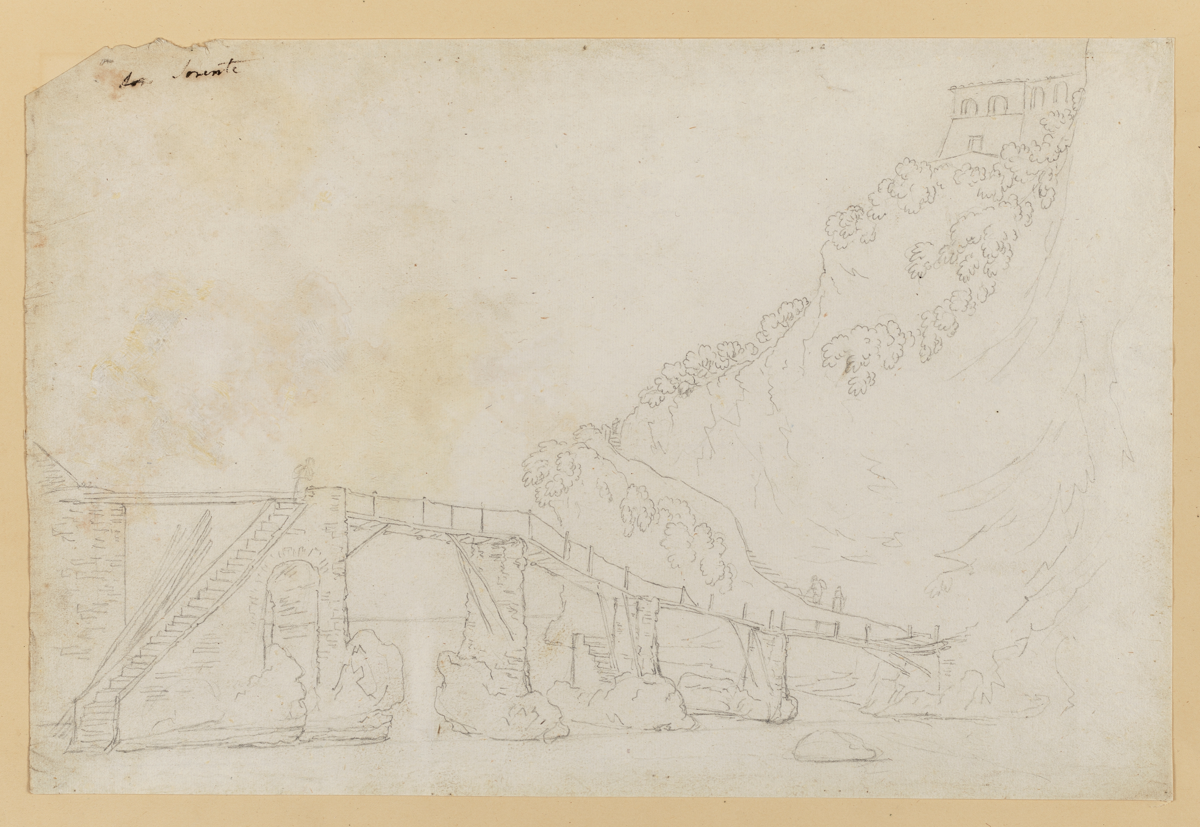 Drawing of a bridge over a river surrounded by hills and cliffs. Identified as the old bridge at Sorente (Sorrento, Italy). Inscribed top left (handwritten in ink): '(...) Sorente'. Made by Joseph Wright of Derby (1734-1797), c. 1774-1775. Pencil on laid paper. Displayed in a cream window mount.