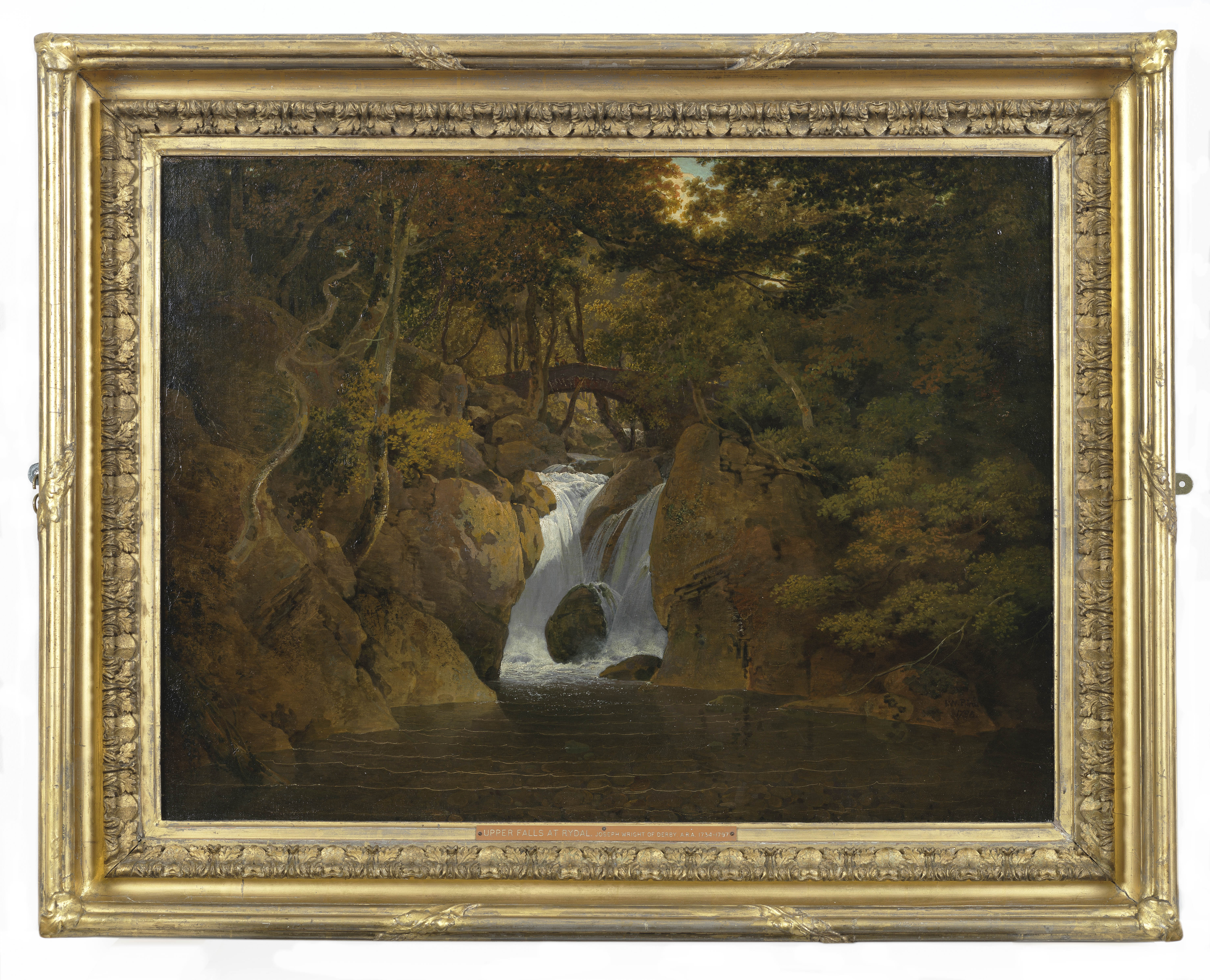 Painting of a waterfall with a bridge beyond. Sunlight peeps through the tree canopy above. The viewpoint is low and looks across the surface of a river towards the waterfall, set within a narrow rocky gorge. Pebbles and rocks are visible benath the water's surface. The canvas is inscribed 'I W Pinxt./ 1795', on a rock, in the lower right hand corner. Painted by Joseph Wright of Derby (1734 - 1797). Oil on canvas in gilded frame.