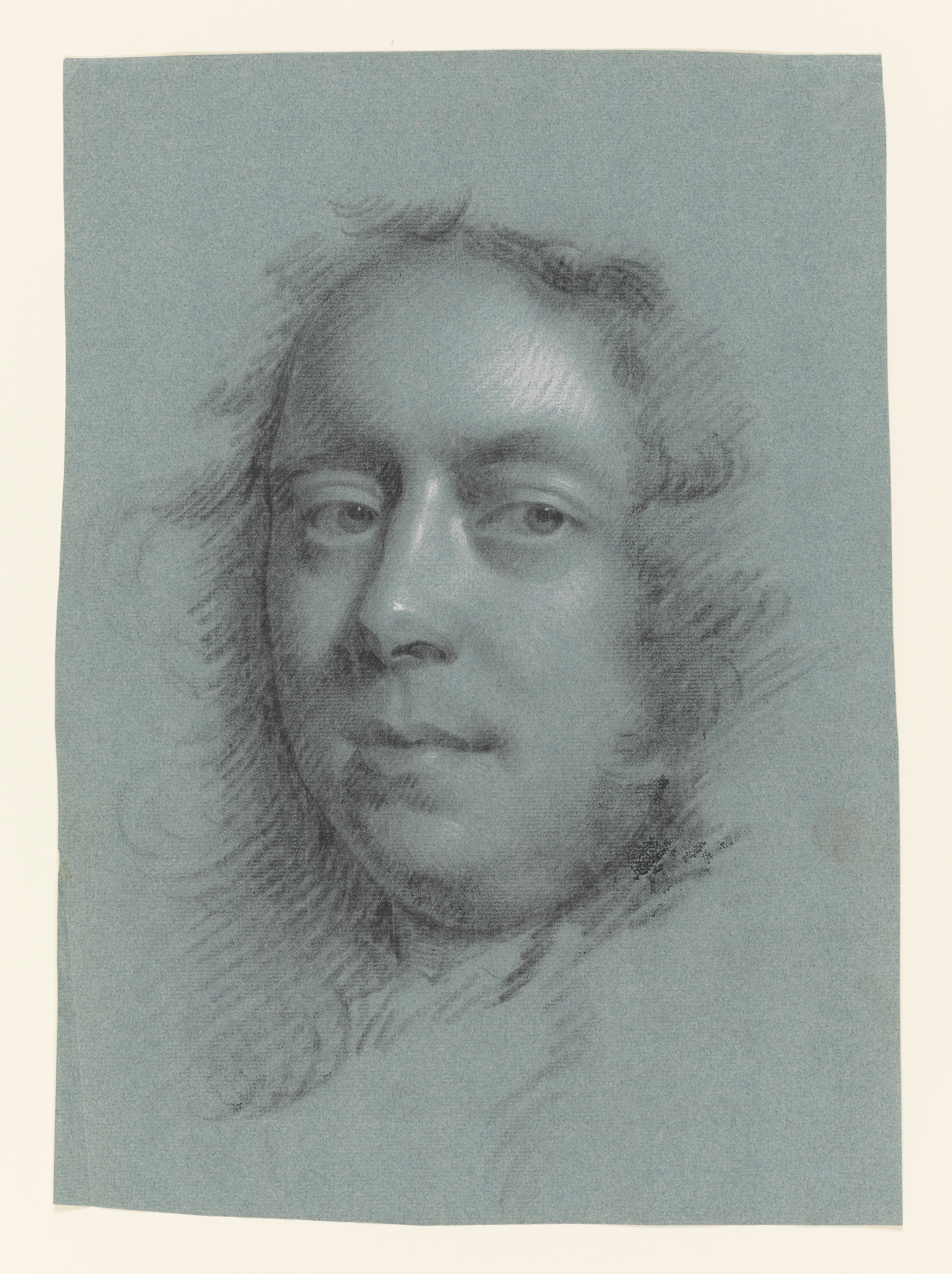 Study of a man, facing slightly to the left, head only. Made by Joseph Wright of Derby (1734 - 1797). Black and white chalk on blue paper, in cream window mount.