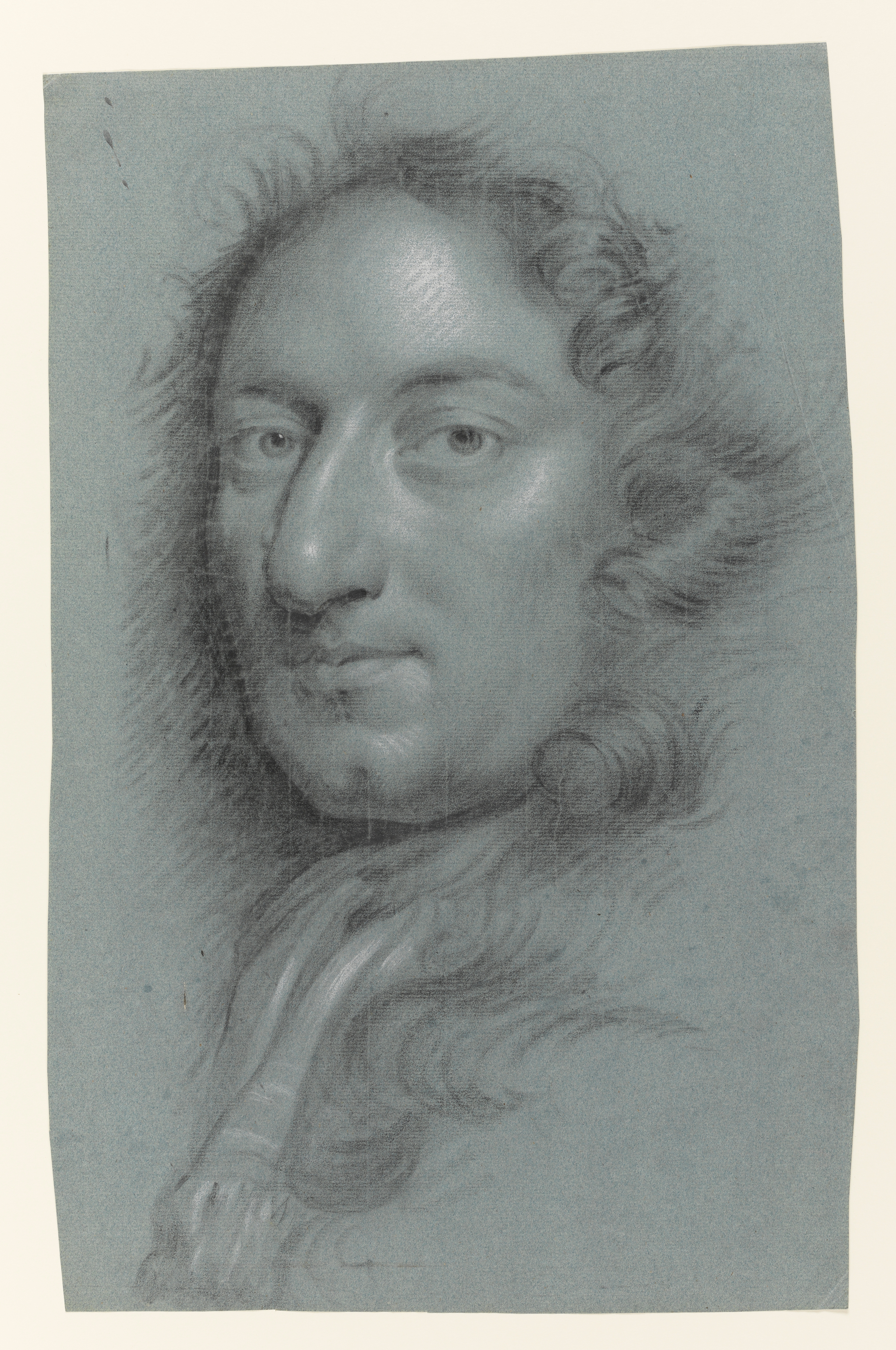 Study of a man, head and shoulders only, facing left. His hair or wig is curled and hangs loose around his face and shoulders. He wears a neckcloth with a stripe through it and a fringe. Made by Joseph Wright of Derby (1734 - 1797). Black and white chalk on blue paper, in cream window mount.