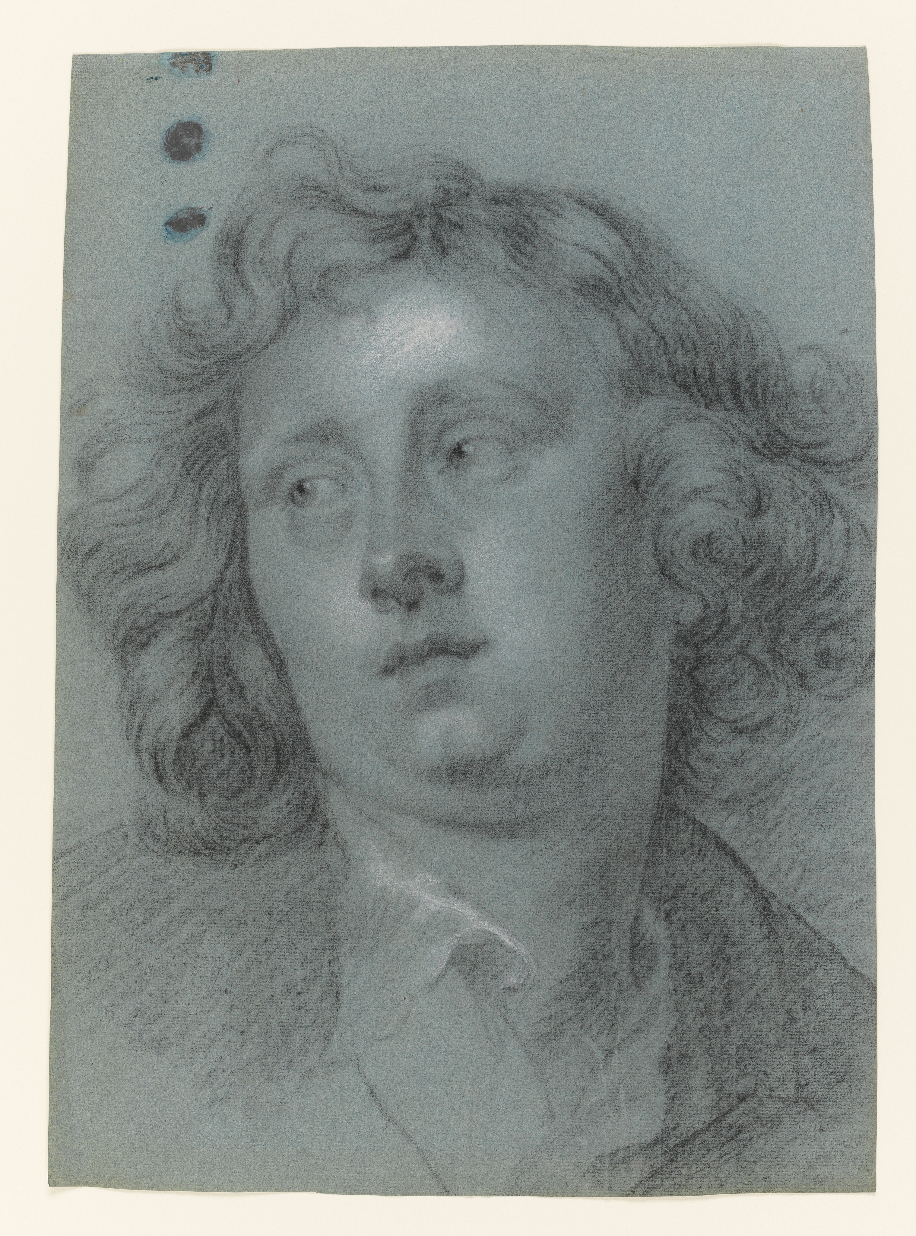 Study of a young man, called Hendrik Liberti, head and shoulders only, turned to the left, his hair loose and his shirt collar open. Made by Joseph Wright of Derby (1734 - 1797). Black and white chalk on blue paper, in cream window mount.