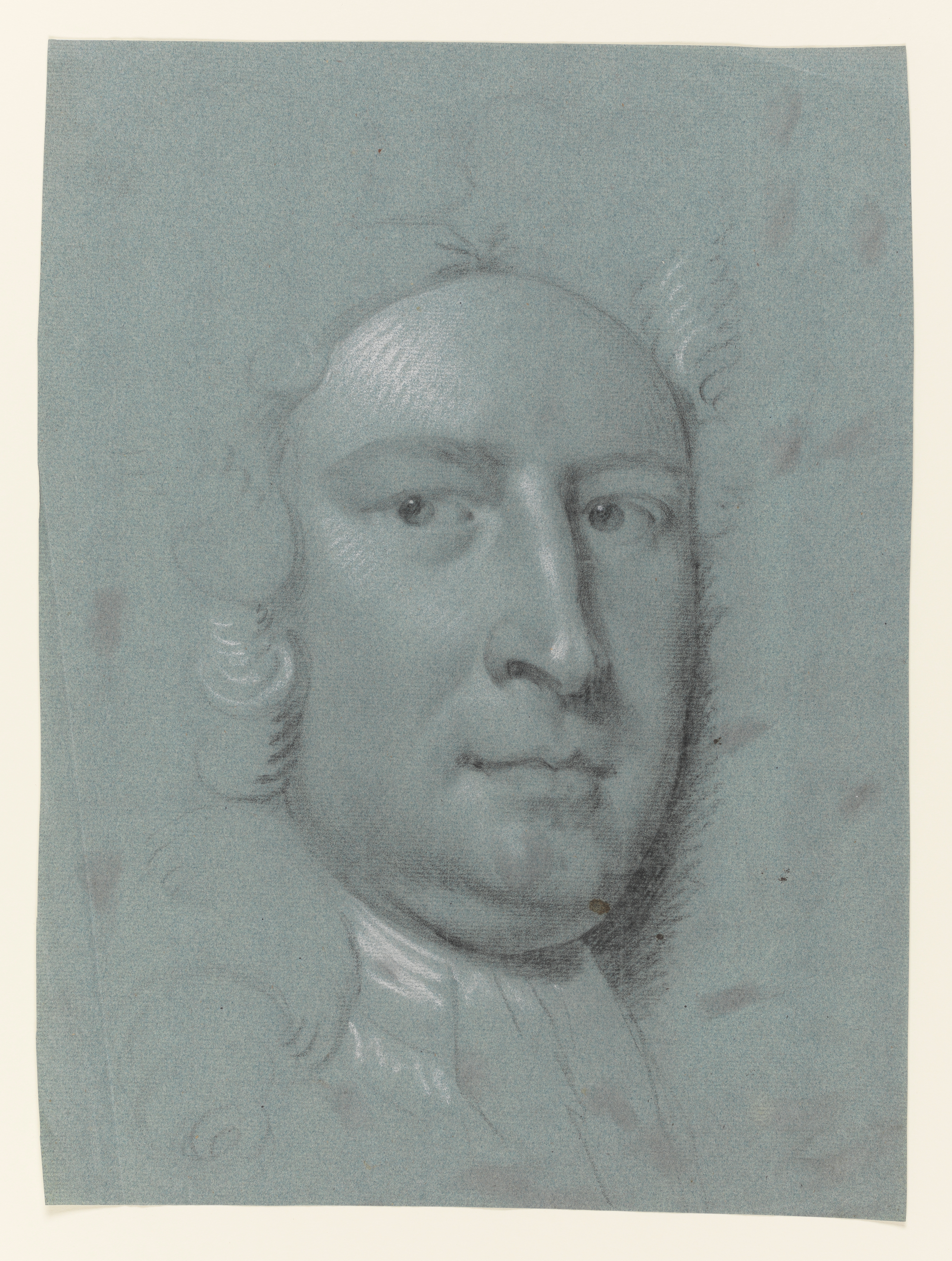 Study of a man, head only, facing slightly to the right. His face is framed by thick curled hair (or a wig), which falls past his shoulders. He wears a simple white neckcloth or stock. Made by Joseph Wright of Derby (1734 - 1797). Black and white chalk on blue paper, in cream window mount.