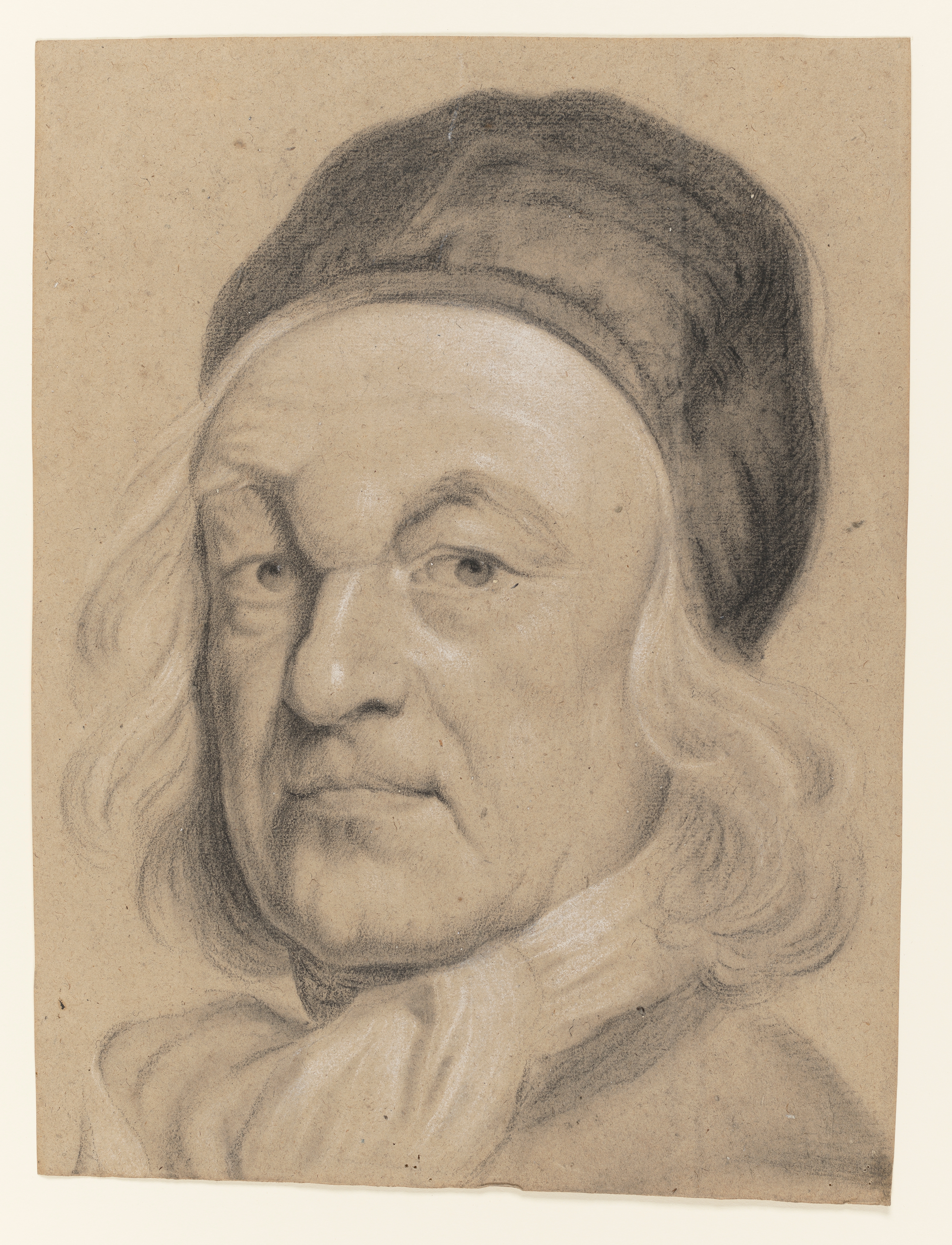 Study of a man, called Charles de Saint-Evremond; head and shoulders only, facing to the left, wearing a black cap and white neck cloth, his hair loose. Made by Joseph Wright of Derby (1734 - 1797). Black and white chalk on buff paper, in cream window mount.
