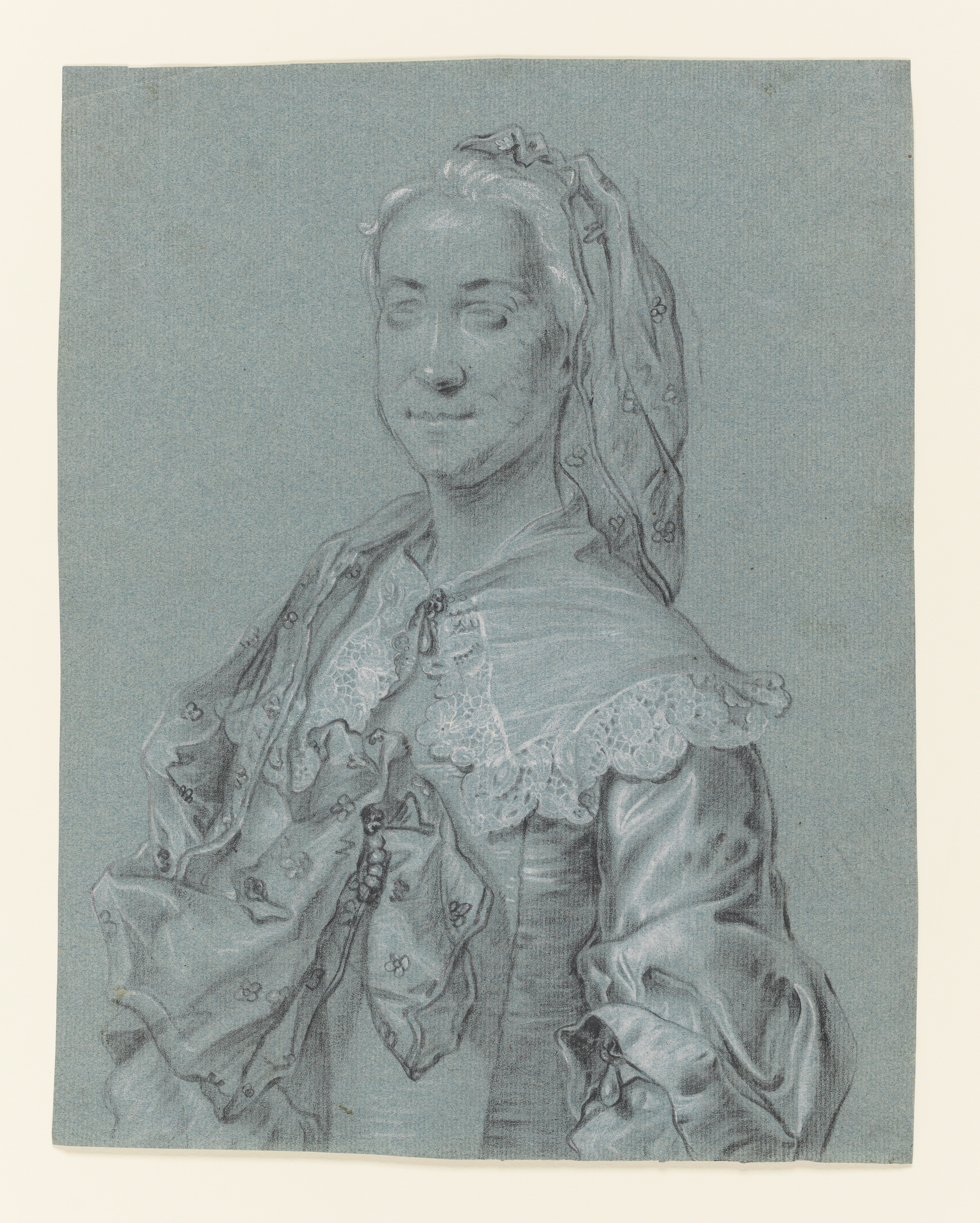 Study of a woman, head and torso only, wearing a lace collar and shawl decorated with flowers, the latter attached to her hair and falling loose around her right shoulder and clasped to the front of her bodice. Her collar is clasped by a drop pearl; the same decorative detail embellishes the bottom of her sleeve. Her face is loosely sketched, the majority of focus being on the details of her dress. Inscribed to verso 'White sattin dress / gauze'. Made by Joseph Wright of Derby (1734 - 1797). Black and white chalk on blue paper, in cream window mount.