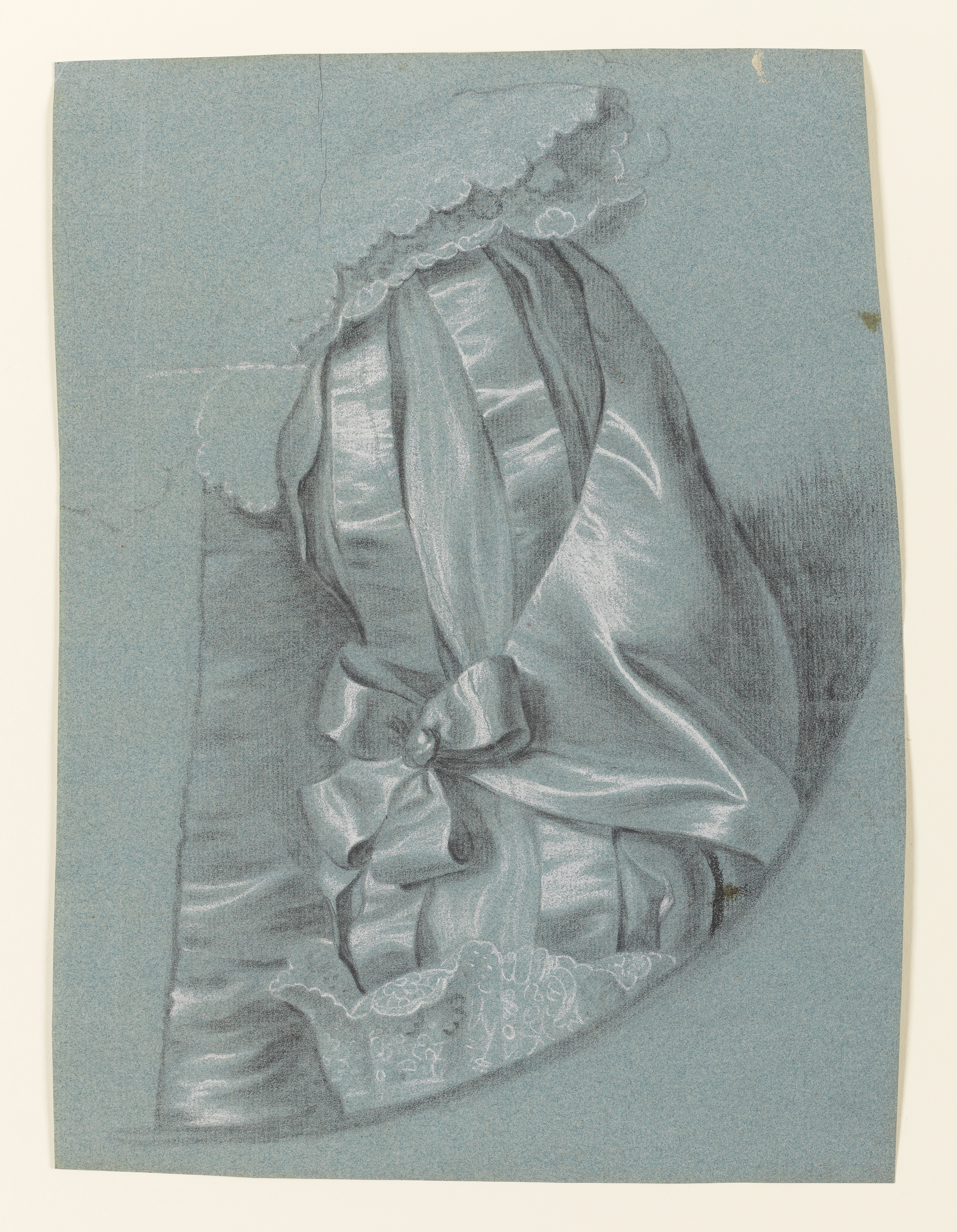 Study of a woman's left arm in Van Dyck dress, consisting of a slashed sleeve, decorated with a bow, lace cuff, and lace collar; the curve of a feigned oval visible below and to the right. Made by Joseph Wright of Derby (1734 - 1797). Black and white chalk on blue laid paper, in cream window mount.