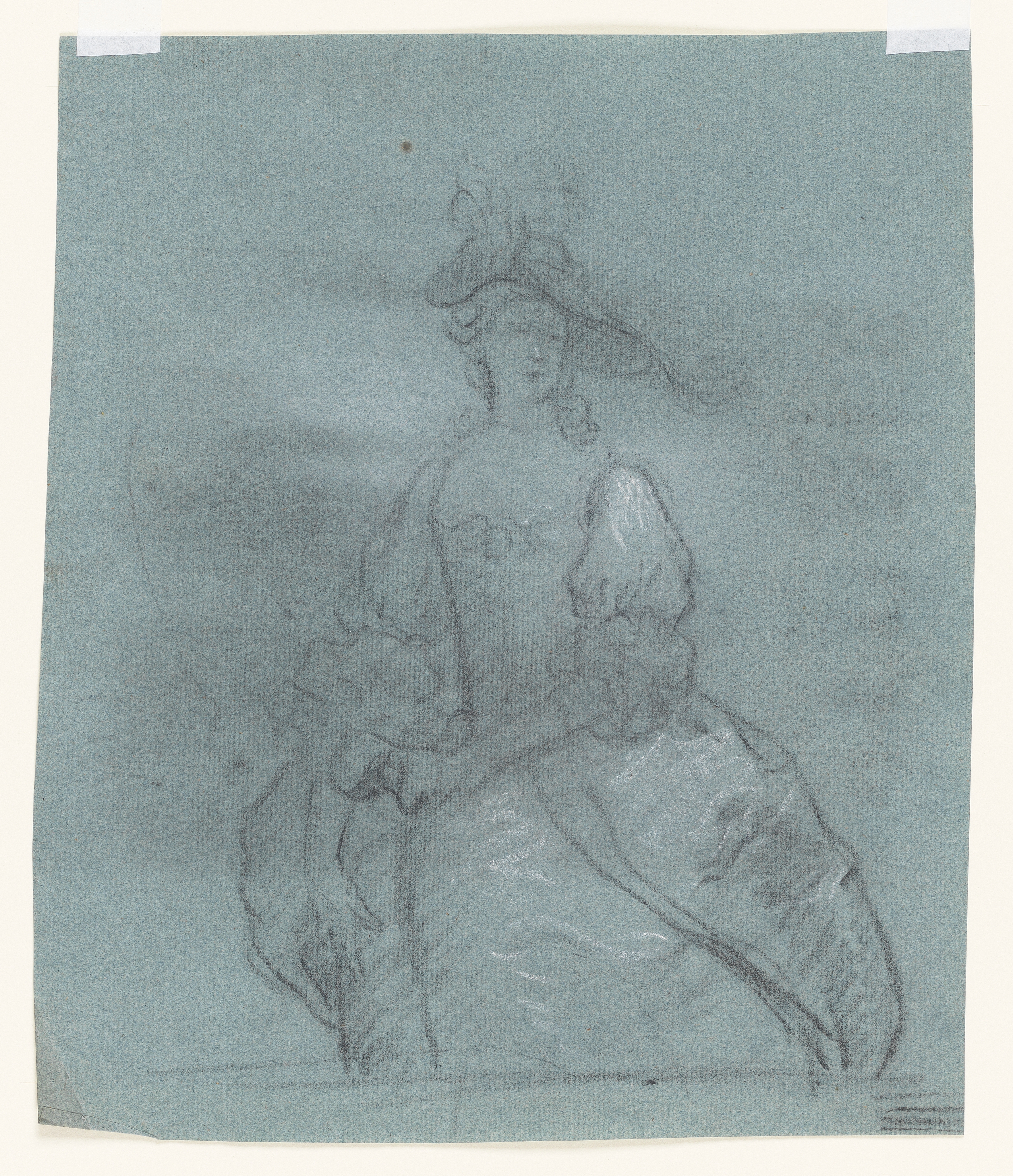 Study of a woman, her head turned slightly to the right, holding a mask in her left hand. She wears an elaborately decorated hat and an open-fronted gown. Drawn by Joseph Wright of Derby (1734 - 1797). Black and white chalk on blue laid paper displayed in a cream window mount.